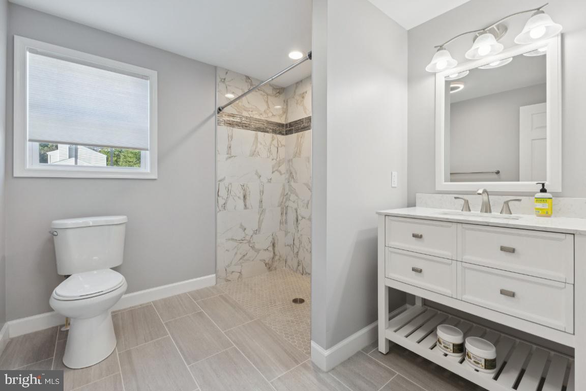 8368 Brock Bridge Road Laurel, MD 20724 - Photo 14 of 37 a bathroom with a toilet a sink and shower