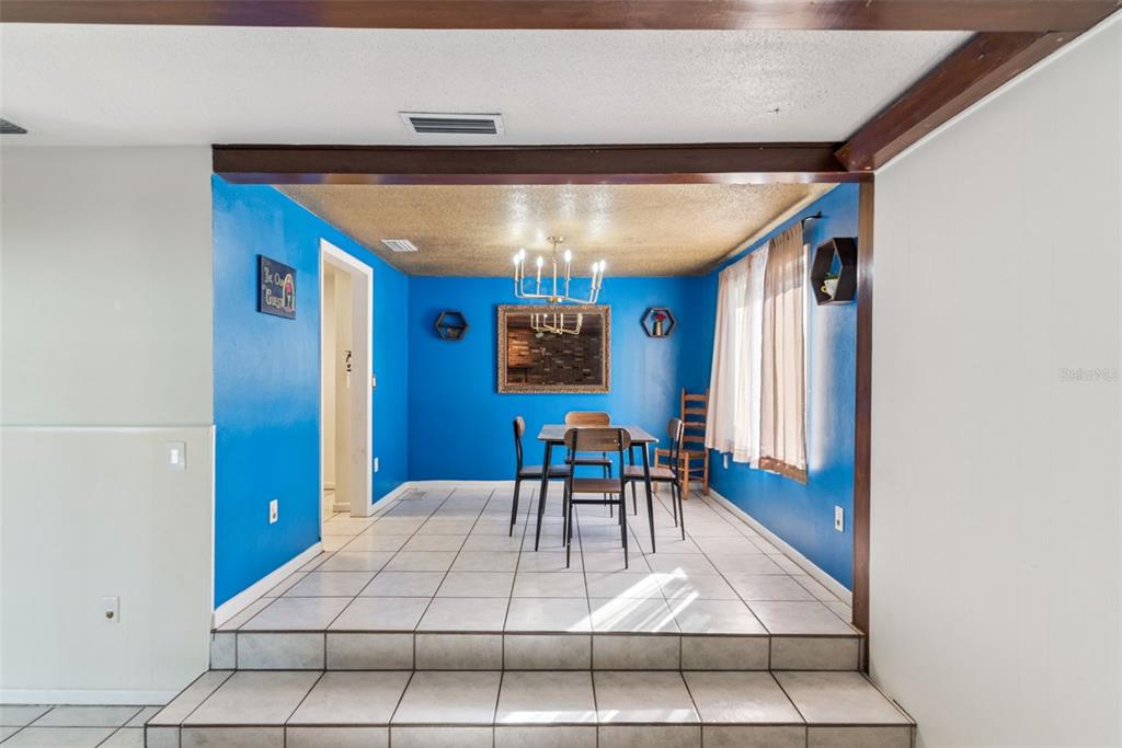 2508 Good Homes Road Orlando, FL 32818 - Photo 11 of 30 a view of a dining room with furniture and chandelier