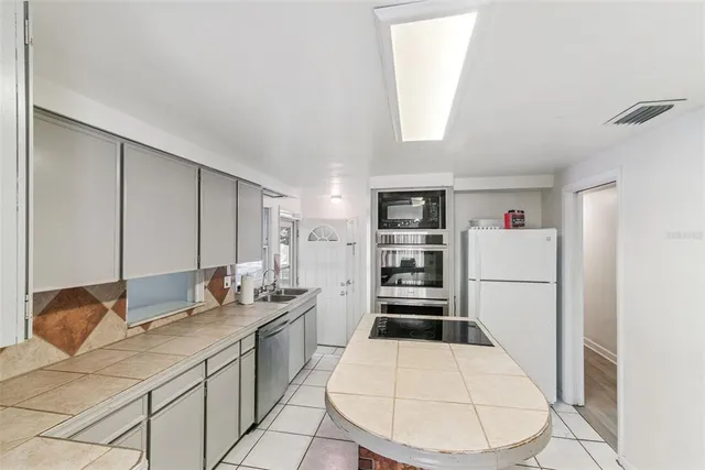 a kitchen with a sink stove and cabinets