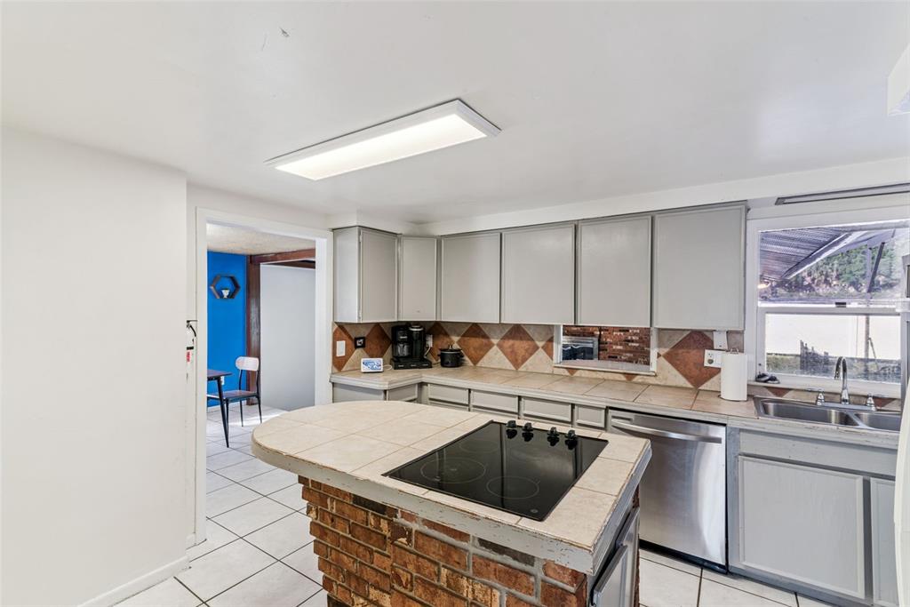 2508 Good Homes Road Orlando, FL 32818 - Photo 14 of 30 a kitchen with a sink stove and cabinets