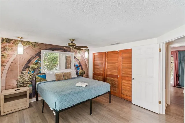 a bedroom with furniture and a flat screen tv