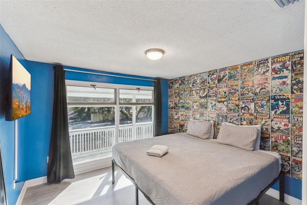 2508 Good Homes Road Orlando, FL 32818 - Photo 21 of 30 a bedroom with a bed and a flat screen tv