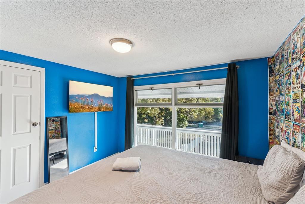 2508 Good Homes Road Orlando, FL 32818 - Photo 22 of 30 a bedroom with furniture and a flat screen tv