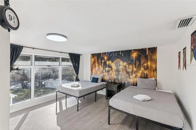 a bedroom with a bed and a large window