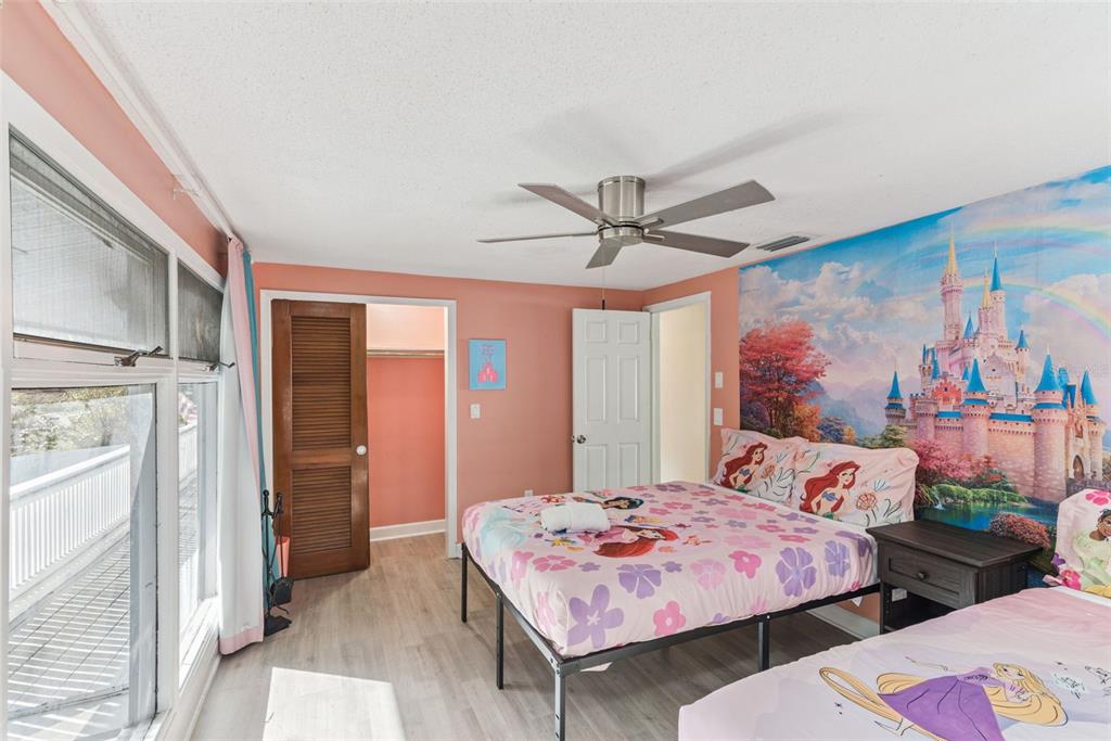 2508 Good Homes Road Orlando, FL 32818 - Photo 24 of 30 a bedroom with a bed a chandelier and a window