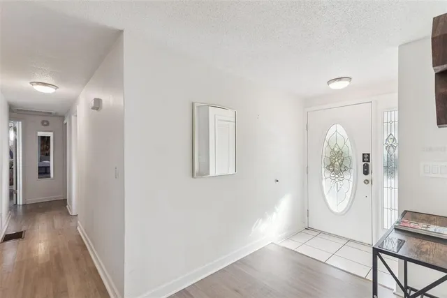 a view of an entryway with wooden floor