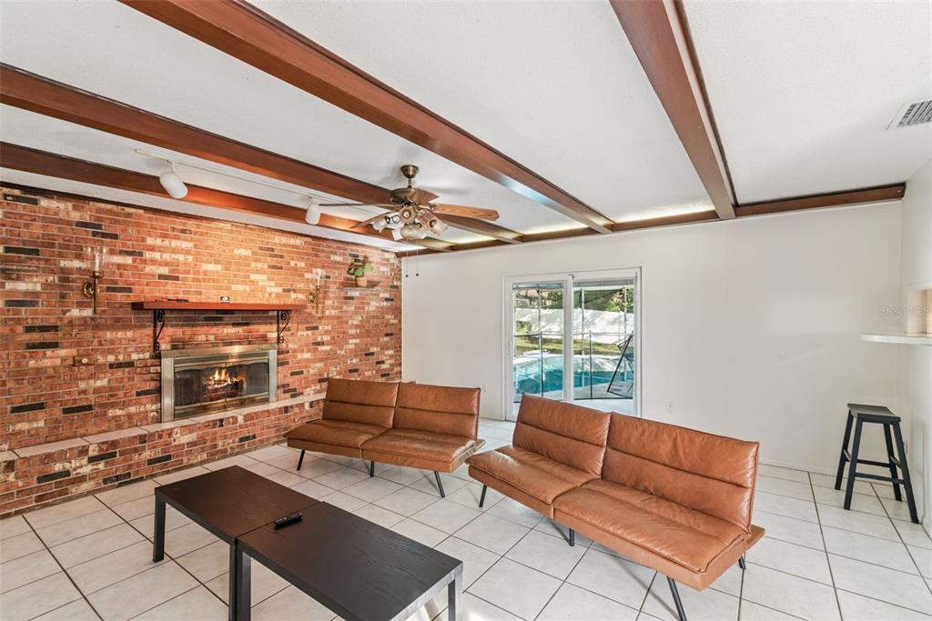 2508 Good Homes Road Orlando, FL 32818 - Photo 8 of 30 a living room with furniture and a floor to ceiling window