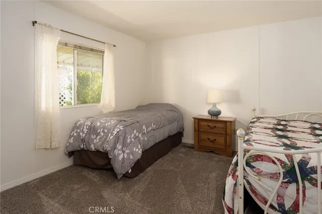 a bed sitting in a bedroom next to a cabinet