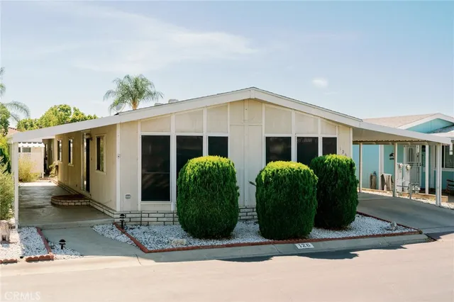 a front view of house with yard and glass windows