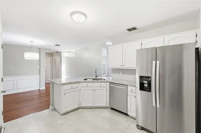 a kitchen with a sink stainless steel appliances and cabinets