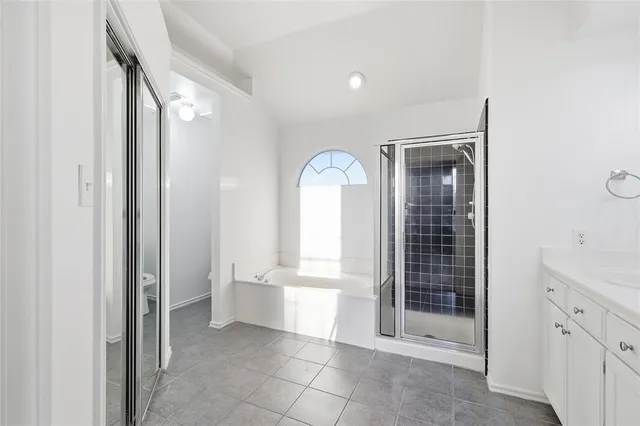 a view of a bathroom with tub and shower