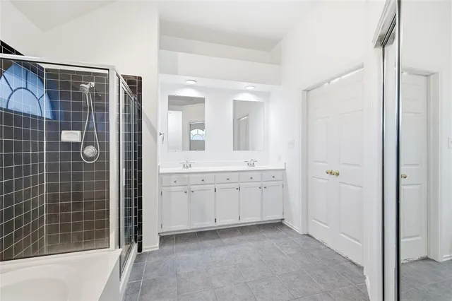 a spacious bathroom with a shower and a sink