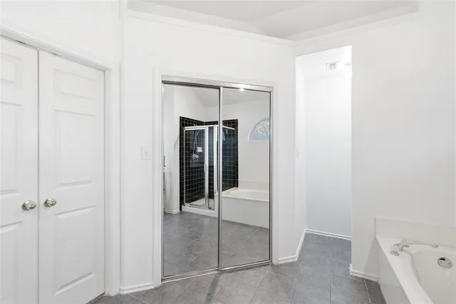 a walk in closet with a bathroom