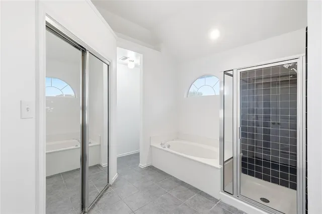 a bathroom with a bathtub and a shower