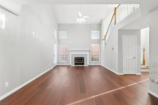 a view of a livingroom with wooden floor and a fireplace