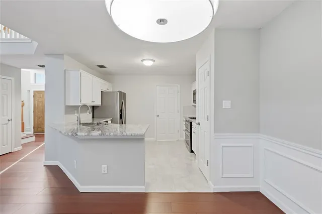 a view of large kitchen with stainless steel appliances