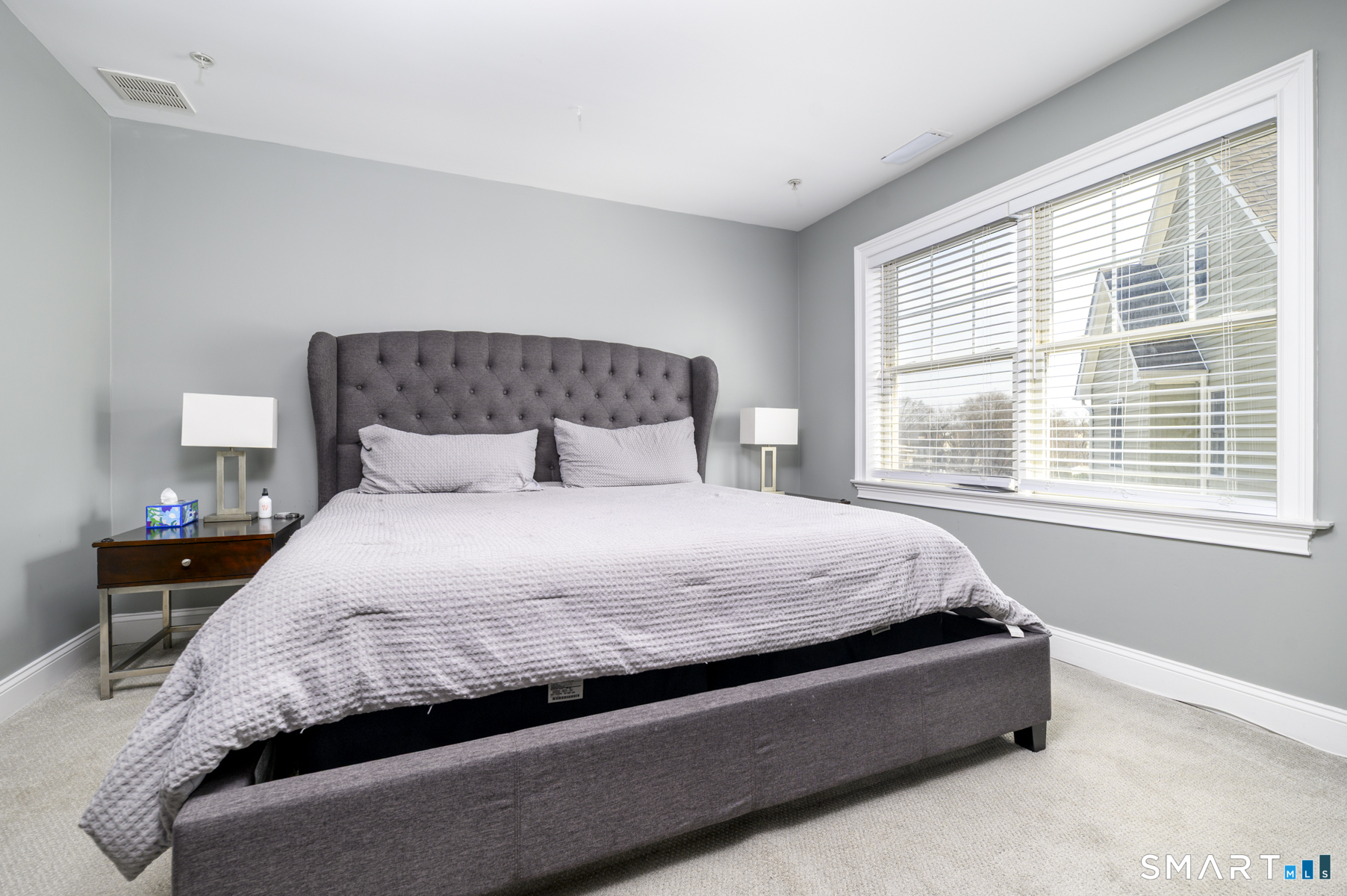 130 Main Street, Unit E4 Norwalk, CT 06851 - Photo 15 of 32 a spacious bedroom with a bed and a large window