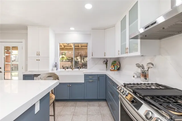a kitchen with a stove a sink a table and chairs