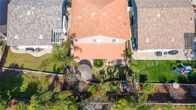 an aerial view of a residential apartment building with a yard and parking
