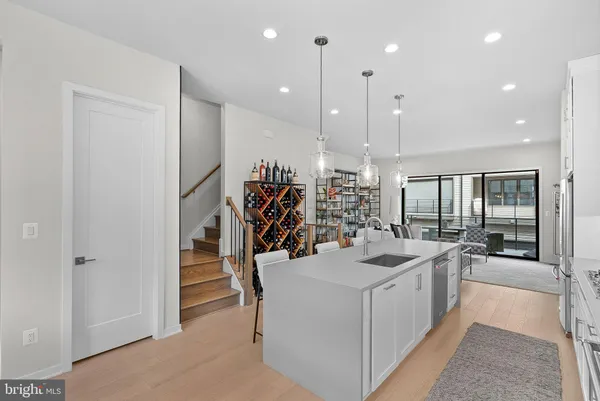 a kitchen with a sink and chairs