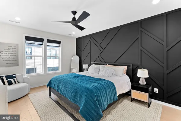 a bedroom with a bed tv and a window