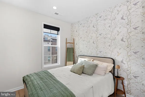 a bedroom with a bed and a couch