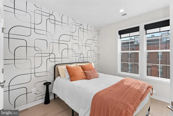 a bedroom with a bed and a painting on the wall