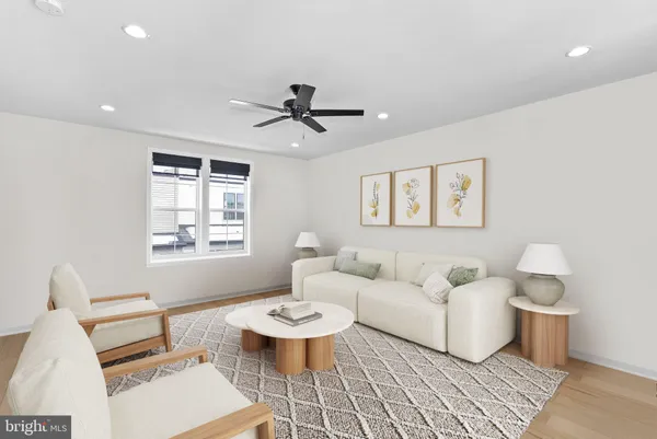 a living room with furniture a rug and a chandelier