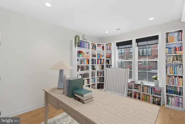 a living room with a book shelf and a book shelf