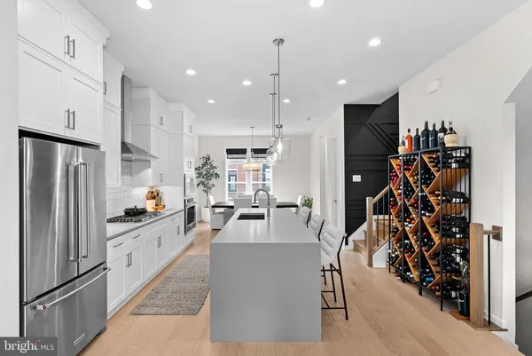 a kitchen with stainless steel appliances granite countertop a refrigerator and a sink