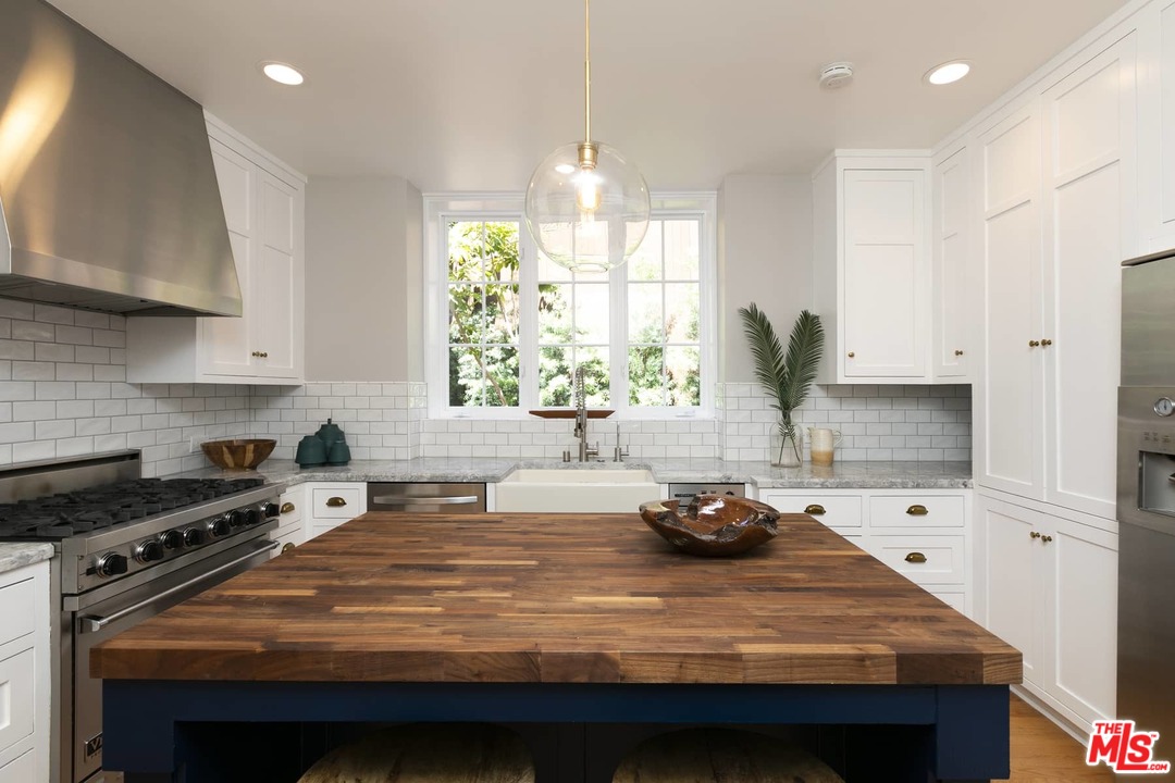 2529 North Commonwealth Avenue Los Angeles, CA 90027 - Photo 12 of 37 a kitchen with kitchen island granite countertop a sink appliances and cabinets