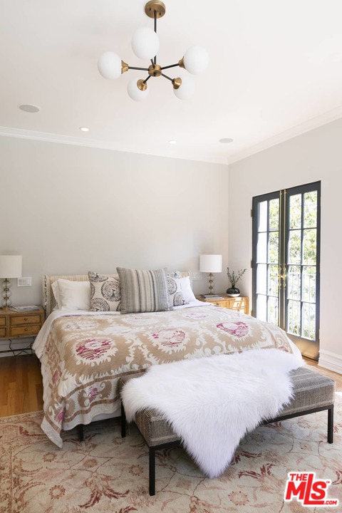 2529 North Commonwealth Avenue Los Angeles, CA 90027 - Photo 14 of 37 a bedroom with a bed and a chandelier