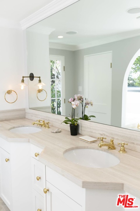 2529 North Commonwealth Avenue Los Angeles, CA 90027 - Photo 17 of 37 a bathroom with a sink and a mirror