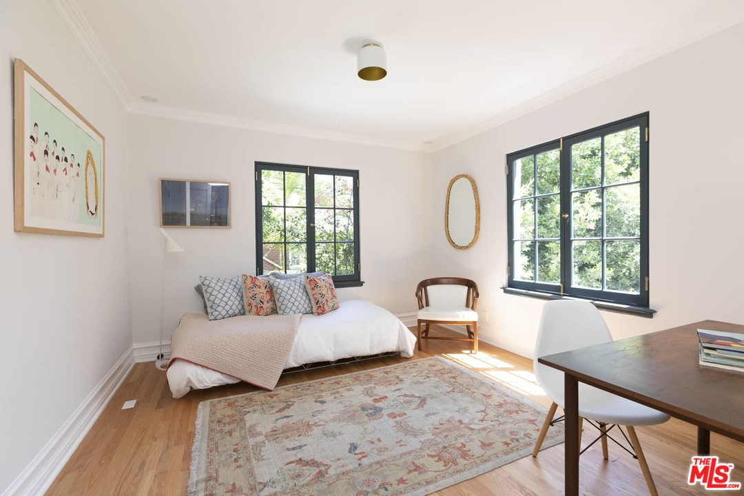 2529 North Commonwealth Avenue Los Angeles, CA 90027 - Photo 23 of 37 a bedroom with a bed and a table with windows