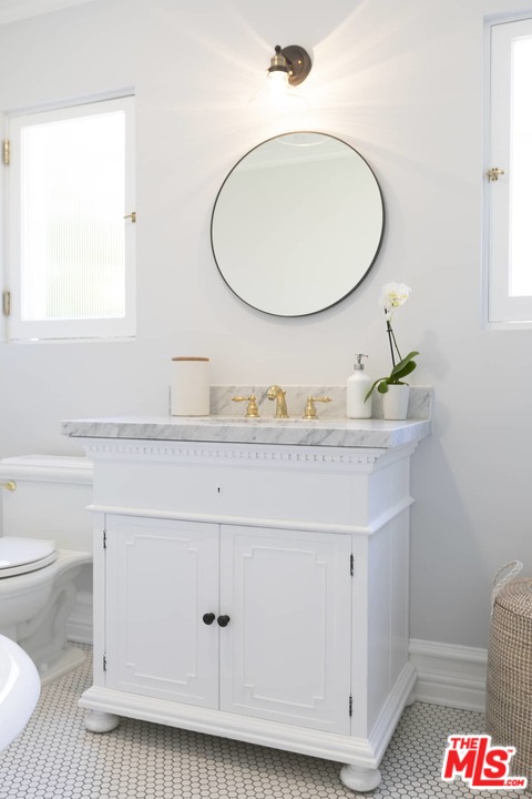 2529 North Commonwealth Avenue Los Angeles, CA 90027 - Photo 26 of 37 a bathroom with a sink and a mirror