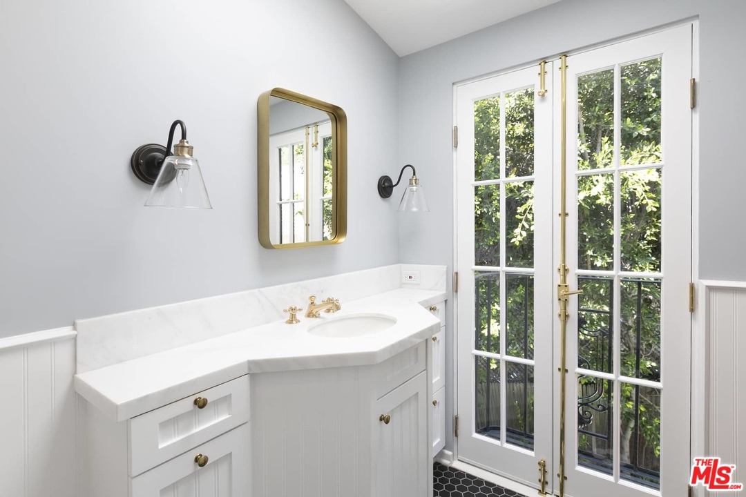 2529 North Commonwealth Avenue Los Angeles, CA 90027 - Photo 28 of 37 a bathroom with a sink mirror and vanity