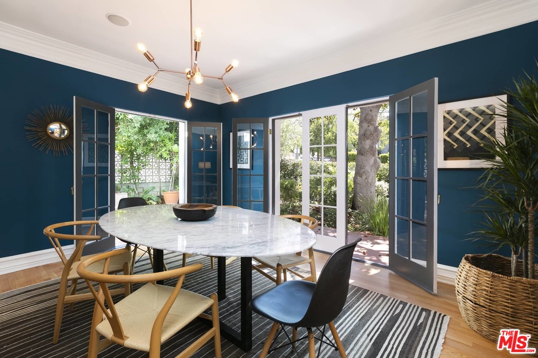 2529 North Commonwealth Avenue Los Angeles, CA 90027 - Photo 8 of 37 a view of a dining room with furniture wooden floor and chandelier