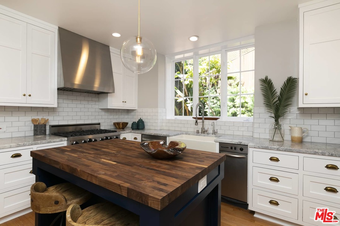 2529 North Commonwealth Avenue Los Angeles, CA 90027 - Photo 10 of 37 a kitchen with a stove a sink and a refrigerator