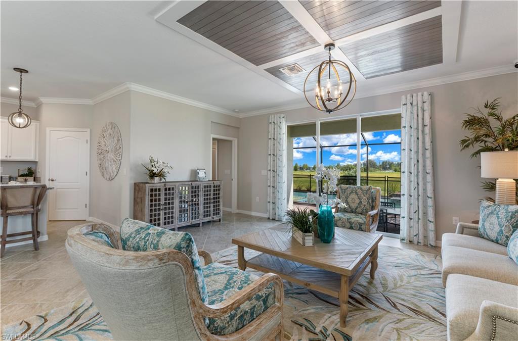 16100 Bonita Landing Circle Bonita Springs, FL 34135 - Photo 11 of 28 a living room with furniture a chandelier and a table