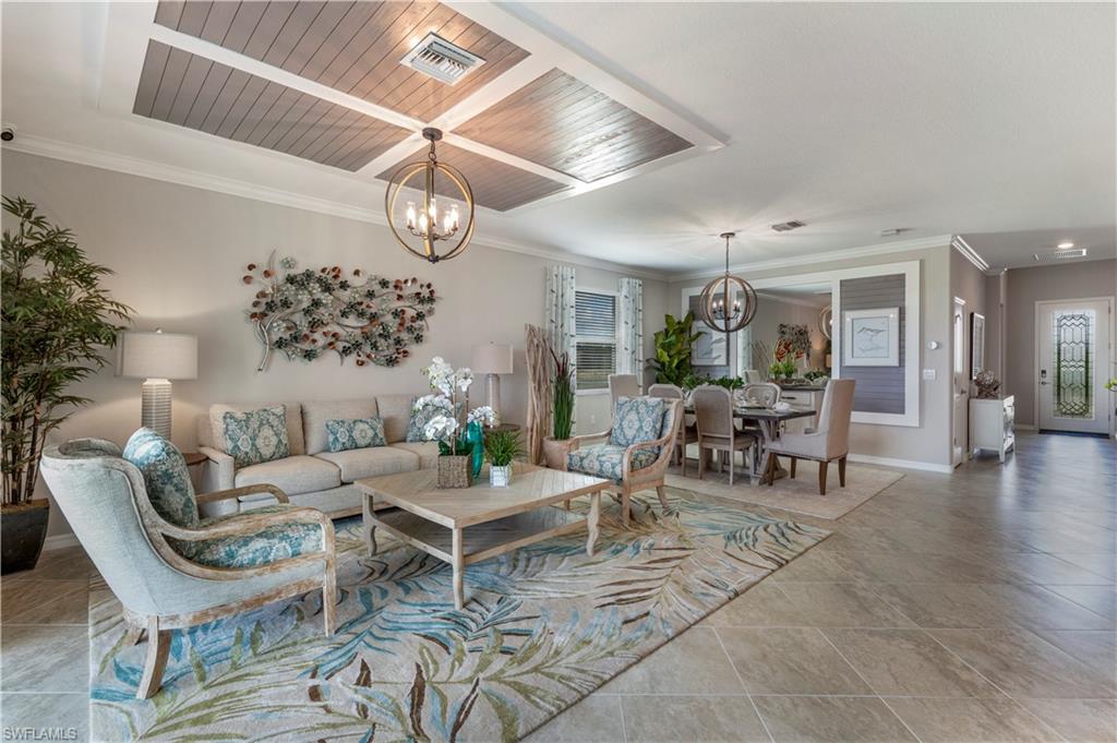 16100 Bonita Landing Circle Bonita Springs, FL 34135 - Photo 12 of 28 a living room with furniture a dining table and a chandelier