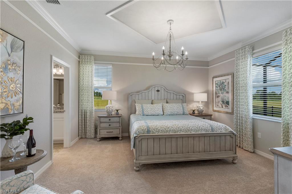 16100 Bonita Landing Circle Bonita Springs, FL 34135 - Photo 13 of 28 a bedroom with a bed chandelier and windows