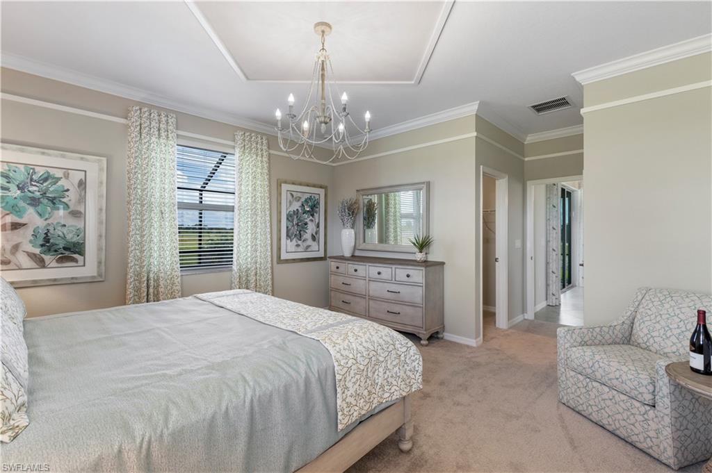 16100 Bonita Landing Circle Bonita Springs, FL 34135 - Photo 15 of 28 a spacious bedroom with a bed and a chandelier
