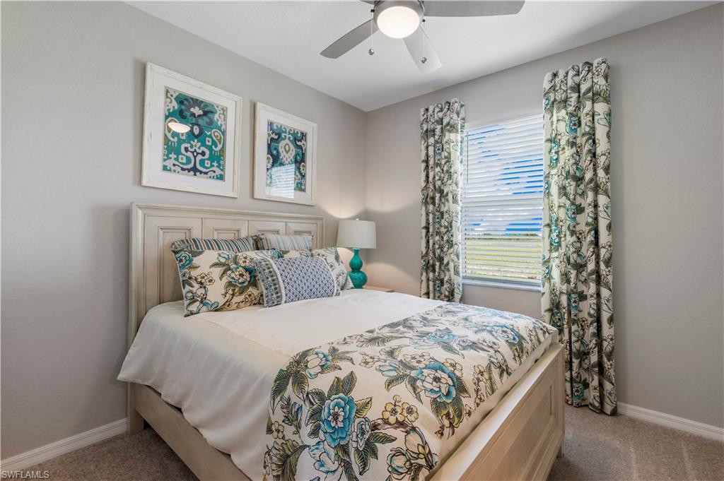 16100 Bonita Landing Circle Bonita Springs, FL 34135 - Photo 20 of 28 a bedroom with a bed and a chandelier