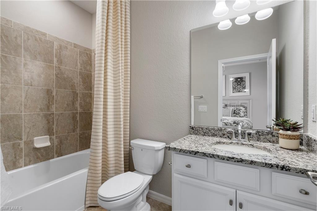 16100 Bonita Landing Circle Bonita Springs, FL 34135 - Photo 21 of 28 a bathroom with a granite countertop sink a toilet and shower