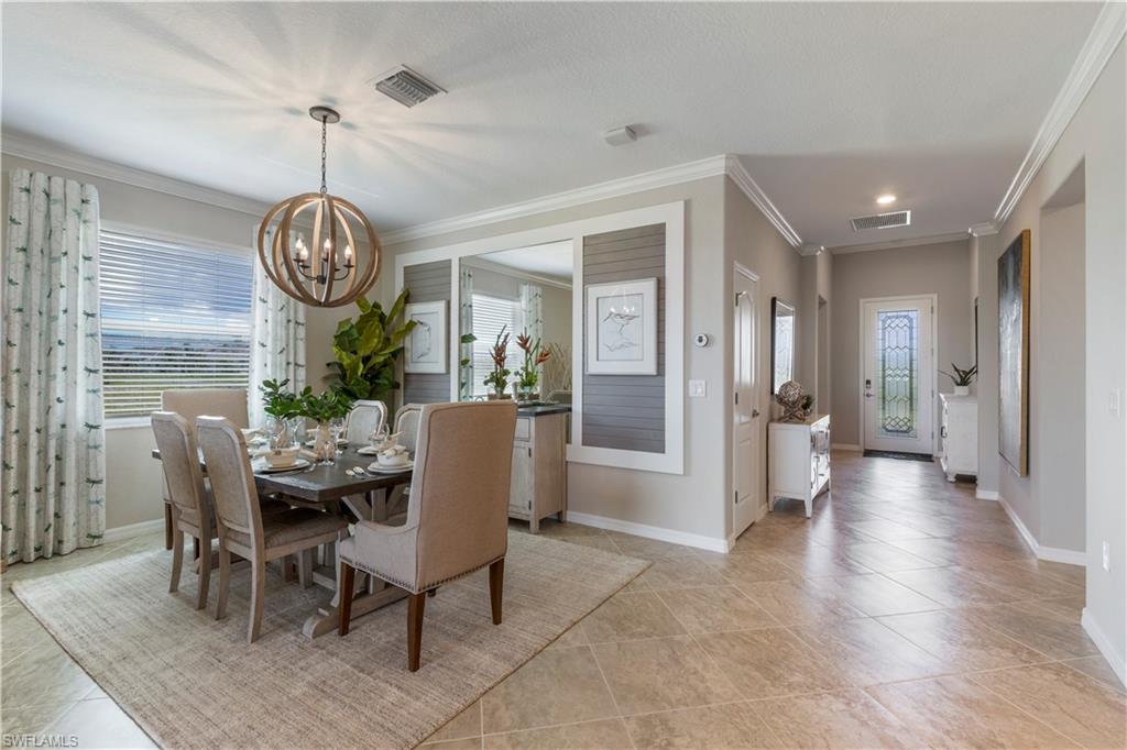 16100 Bonita Landing Circle Bonita Springs, FL 34135 - Photo 5 of 28 a view of a dining room and livingroom with furniture wooden floor a chandelier