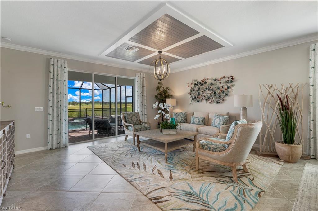 16100 Bonita Landing Circle Bonita Springs, FL 34135 - Photo 10 of 28 a living room with furniture a chandelier and a potted plant