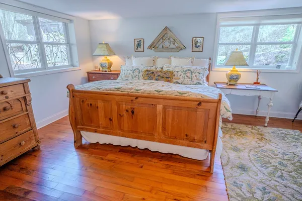 a view of a patio with table and chairs with wooden floor and fence