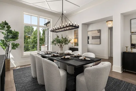a dining room with furniture a chandelier and window