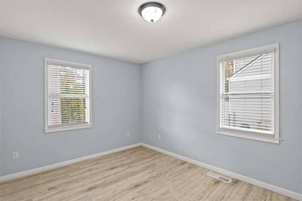701 Daniel Avenue Decatur, GA 30032 - Photo 26 of 29 a view of an empty room with wooden floor and a window
