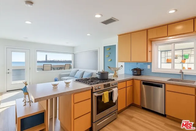 a kitchen that has a sink and a stove in it